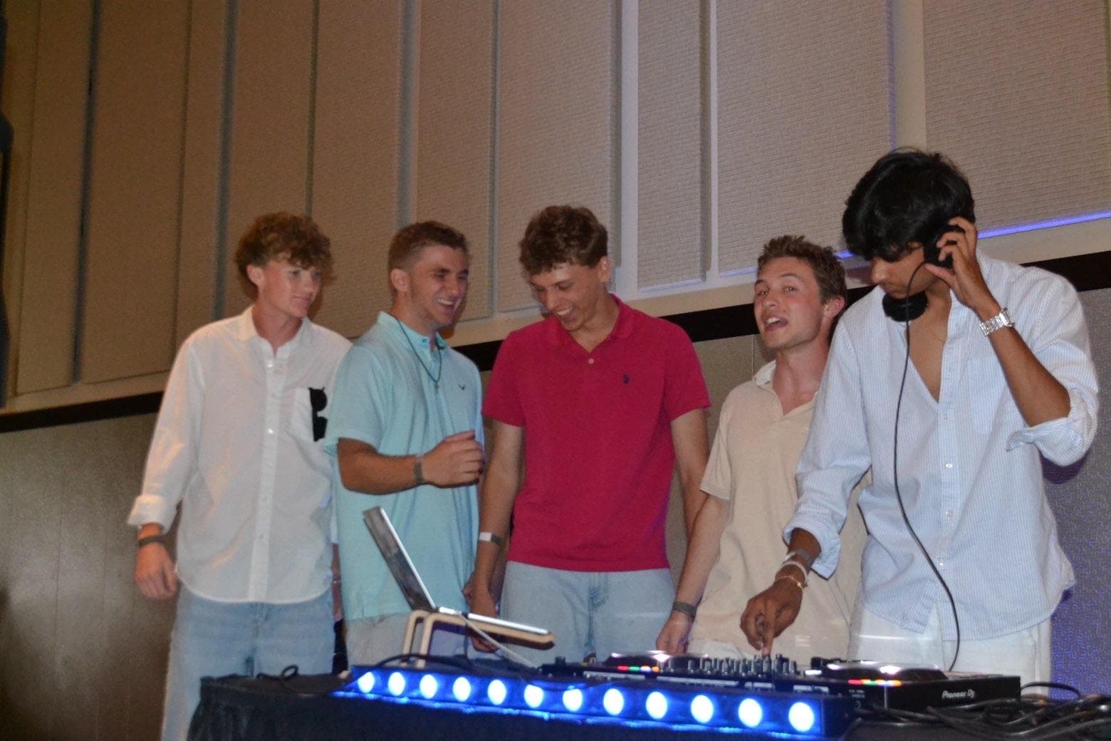 Group behind the DJ booth